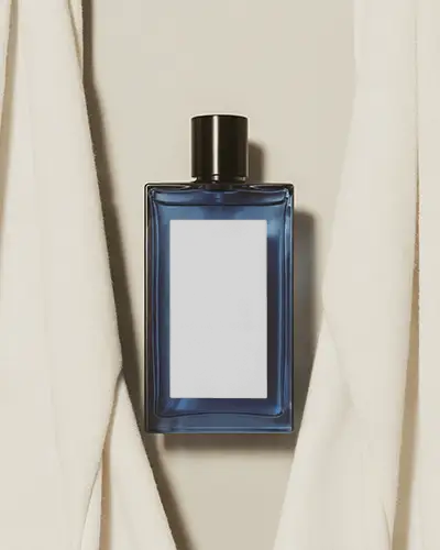 Minimal blue square perfume bottle against draped fabric